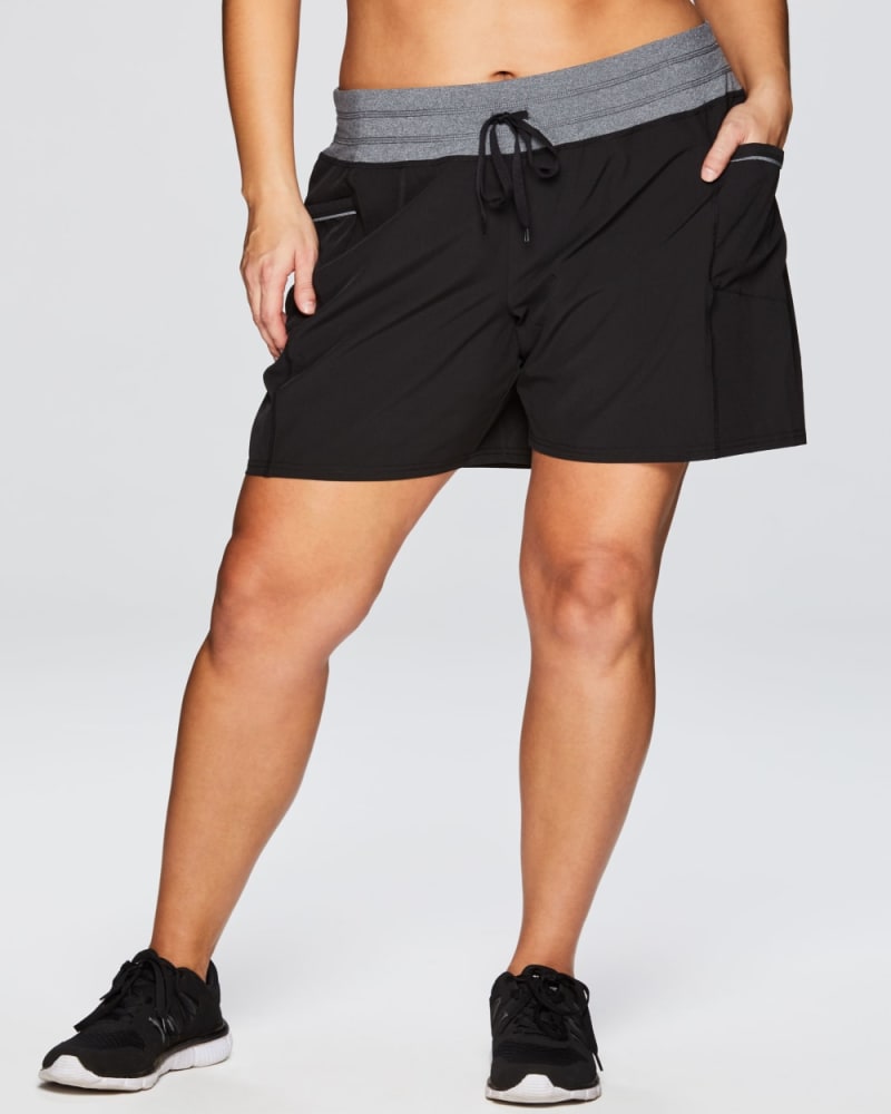 Front of a model wearing a size 2X Plus Lumen Relaxed Fit Short in Black by RBX Active. | dia_product_style_image_id:348472